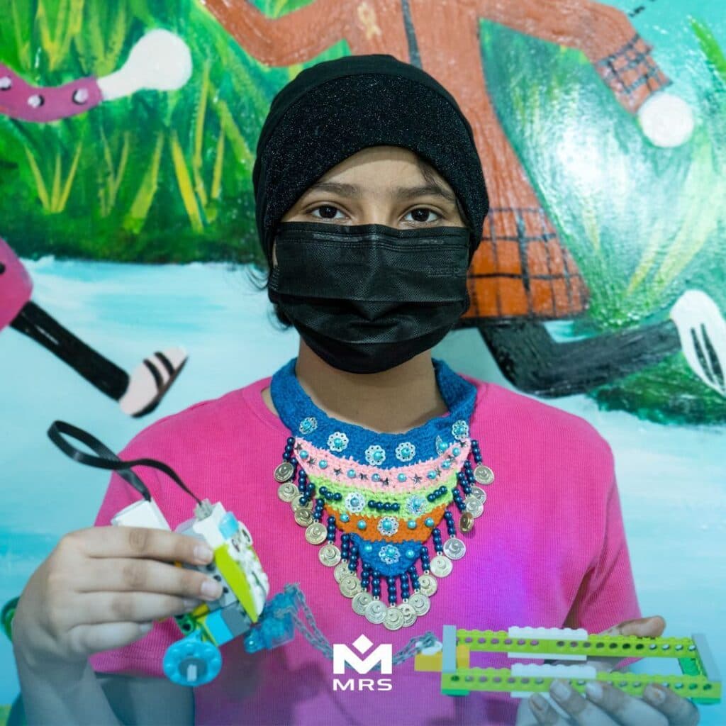 Child smiling after a fun robotics activity | MRS Technologies