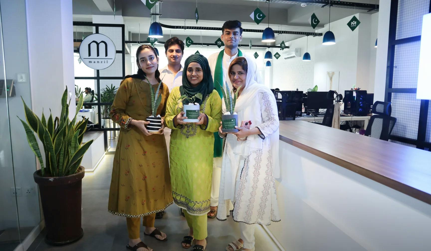 A group of Employees holding different plants on Plantation Drive conducted after Pakistan's Independence Day 2022 | MRS Technologies Pakistan