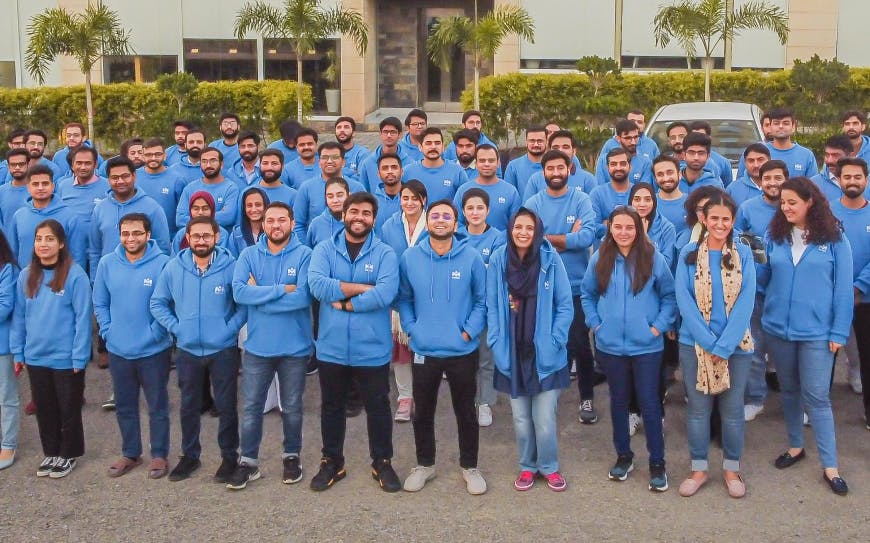 MRS team standing in front of S1 building in Gulberg Green, Islamabad, wearing blue hoodies with white MRS logo | MRS Technologies Pakistan
