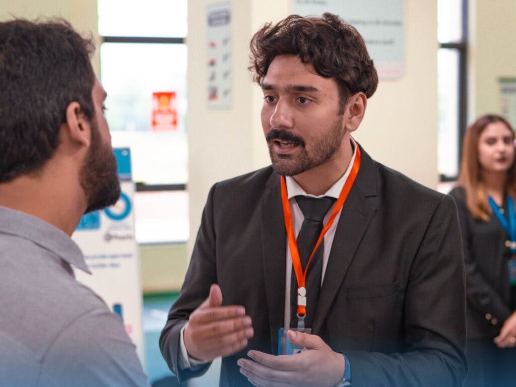 Jawad Faheem engages with a student at Fast Job fair 2023 | MRS Technologies